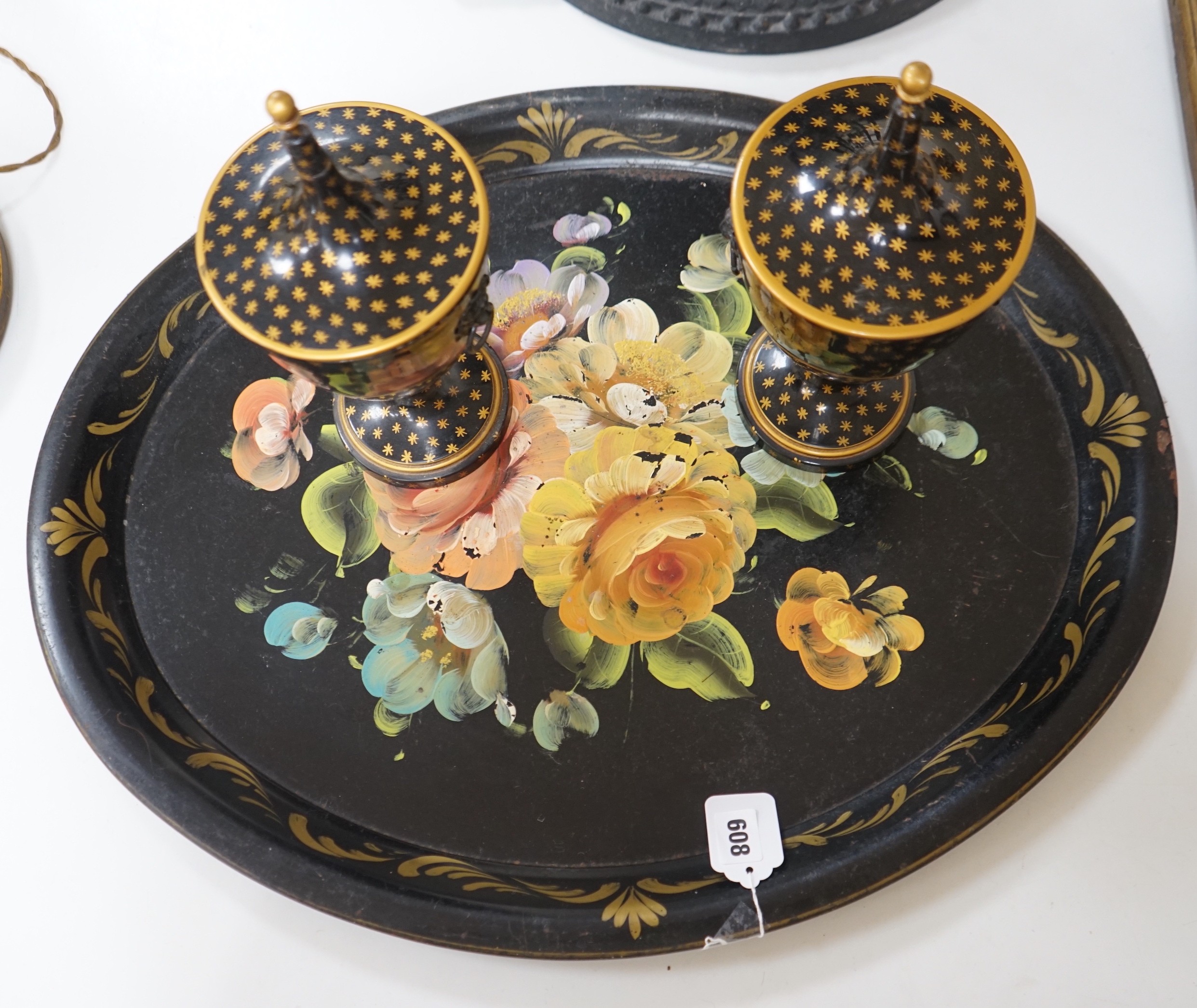 A pair of lidded painted toleware vessels, together with a painted tin toleware tray, 65cm long (3)